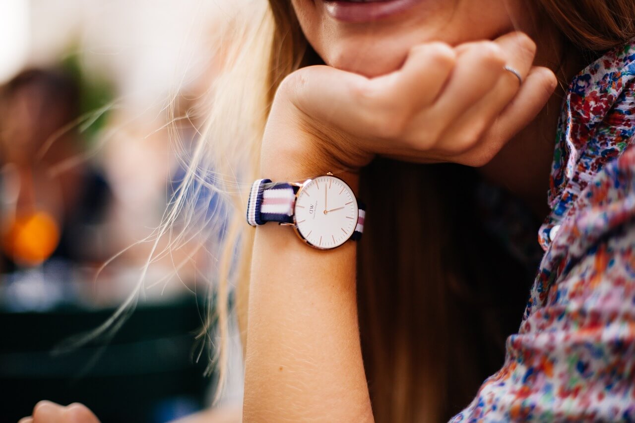 Woman accessorizing with a watch